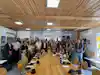 a group of people standing around a table