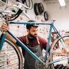 Bike shop owner fixing a bike