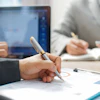 a person holding a pen