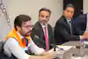 a group of men sitting at a table