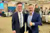 two men in suits standing together