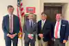 a group of men standing in front of a door