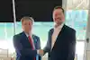 two men shaking hands in a room