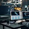 a man in a lab coat looking at a computer screen