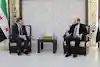 two men sitting in chairs
