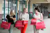 a group of women carrying shopping bags
