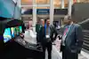 a group of men standing in front of a machine