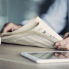 a person reading a newspaper