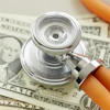 a stethoscope on top of money