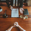 a person sitting at a table with a gavel and a book