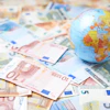a globe on top of money