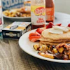 a plate of food and a bottle of syrup
