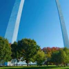 a tall arch with trees in the background
