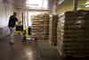 An employee moves bags of flour in the warehouse of a Brighton Mills facility in Cincinnati, OH.