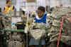 Goodwill participant in Miami making U.S. Army uniforms.