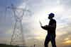 worker looking at power lines