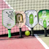 paddles and a ball on a court