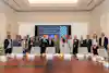a group of people standing in front of a table