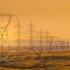 a line of power lines in a field