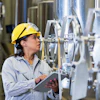 a woman wearing a hard hat and holding a tablet