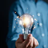 a person holding a light bulb