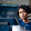 a woman looking at a computer screen