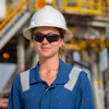 a woman wearing a hard hat and sunglasses