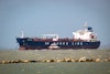 An LNG (liquid natural gas) tanker is being guided into the Port of Corpus Christi.