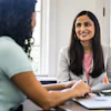 Two women at an office table