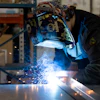 a man welding a metal piece
