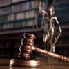 gavel and statue of justice in background
