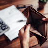 a person holding an empty wallet